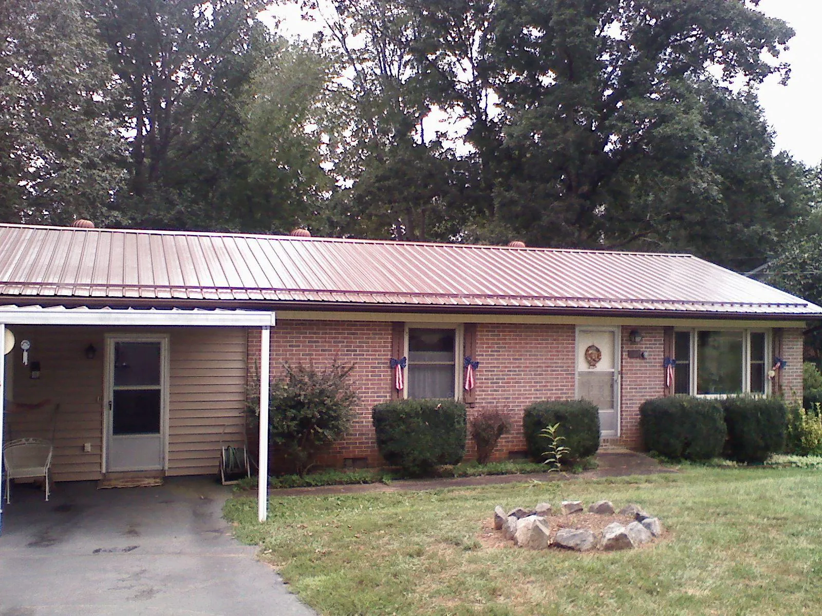 Bronze metal roof and carport on a brick ranch home — Roof Repair work by our crew in Bradfordsville