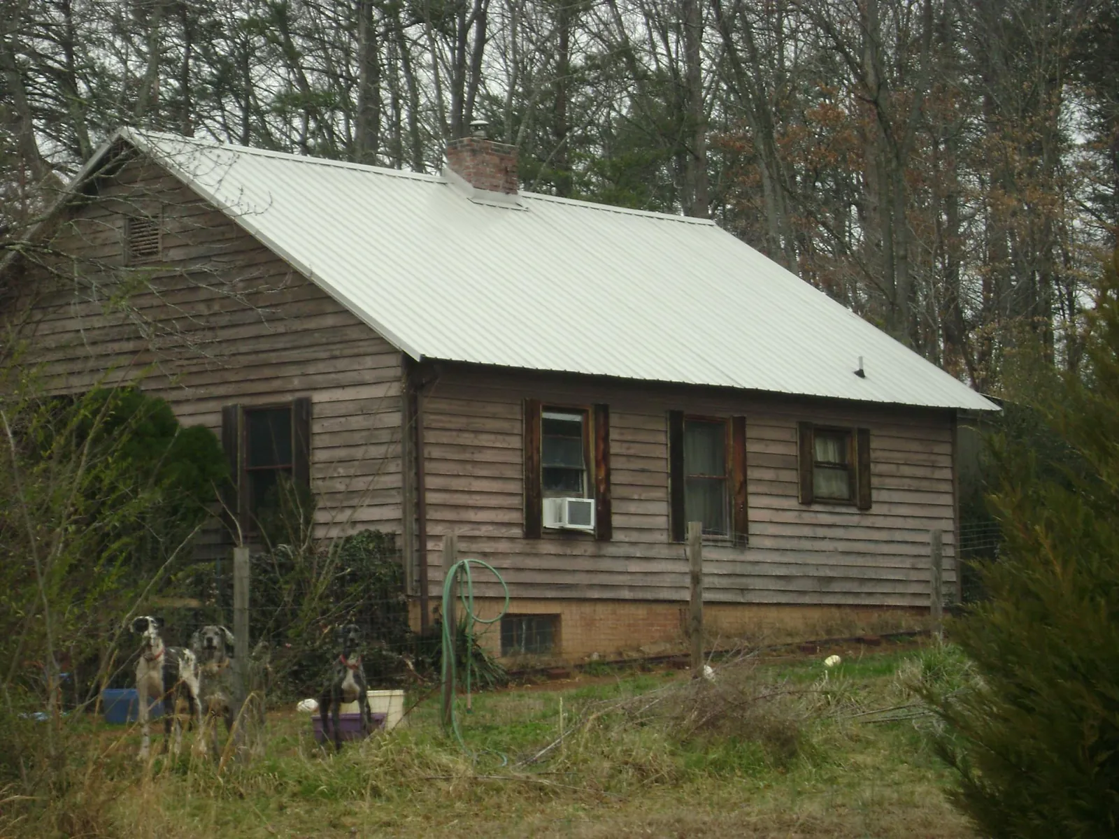 White metal roof on an old wood sided farmhouse, from a Metal Roof Installation job in Bradfordsville